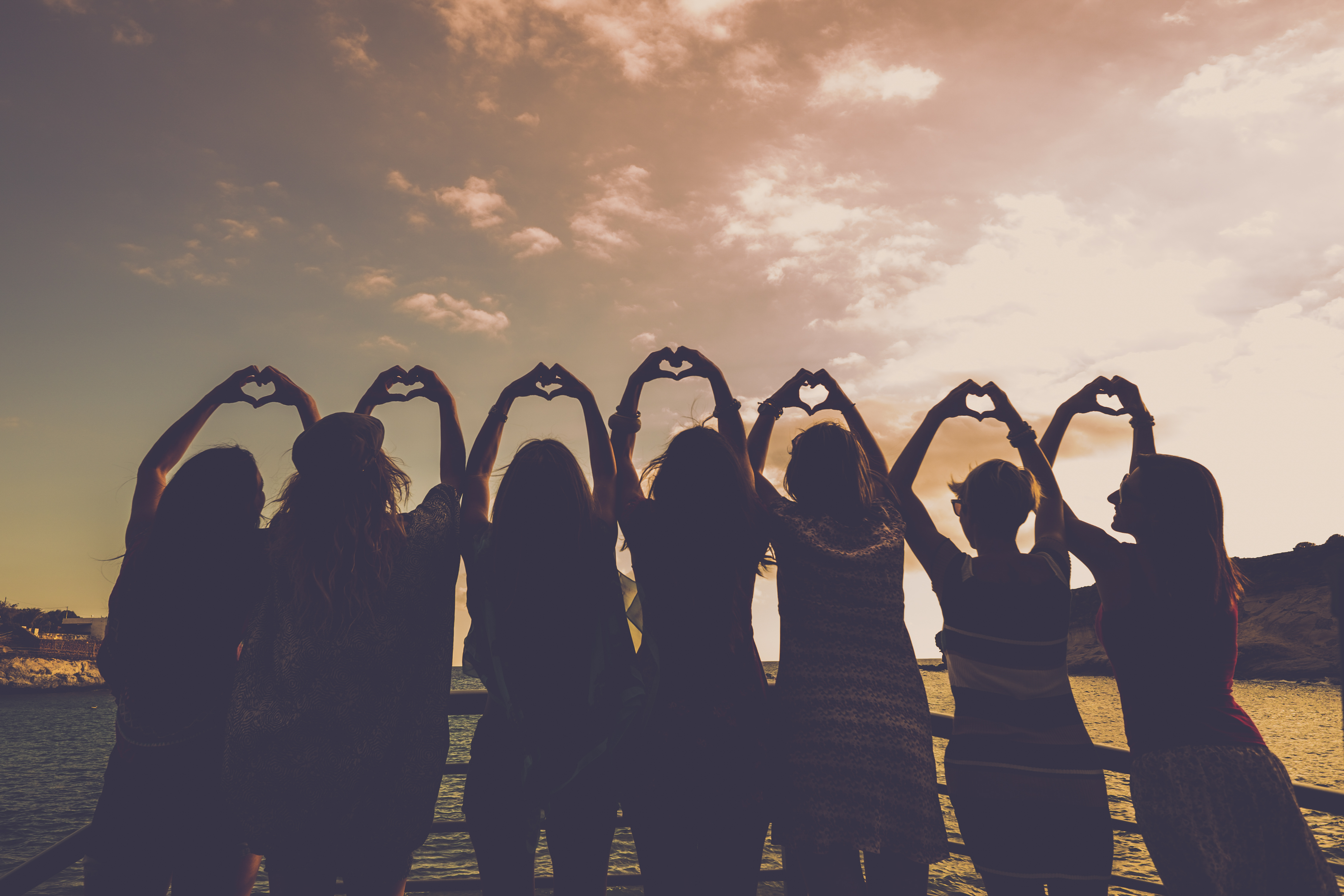 Group of women making hearts with their hands